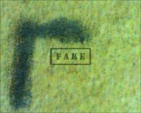 FRANKENSTEIN "MONTAGE" LOBBY CARD - Here we see the "L" in Universal. The microscope image is reversed. Here we should see naked paper with a natural degraded tone, but instead we can clearly see that the paper color itself has been printed with an ink-jet printer. (Poster)